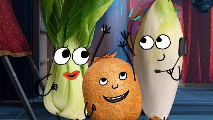 Animated eyes and lips on a pak choi, kiwi and turnip on stage.
