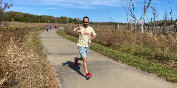 Associate Professor Alex Platt runs during the Women in Law 5K fun run on the trails at Clinton Lake