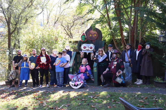 A group of the wonderful Fallout community celebrating Fallout's 25th birthday in front of the a scene of the Flatwoods Monster in cryptozoology in Sutton, West Virginia, where some of Fallout 76 takes place. 