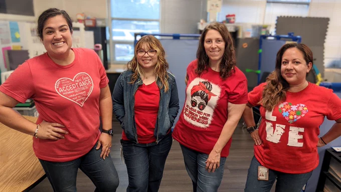 4 rockstar teachers standing in a row showing off their red shirts for red ribbon week!