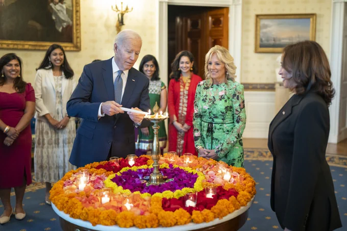 President Biden, alongside the First Lady, lights the diya during the celebration of Diwali.