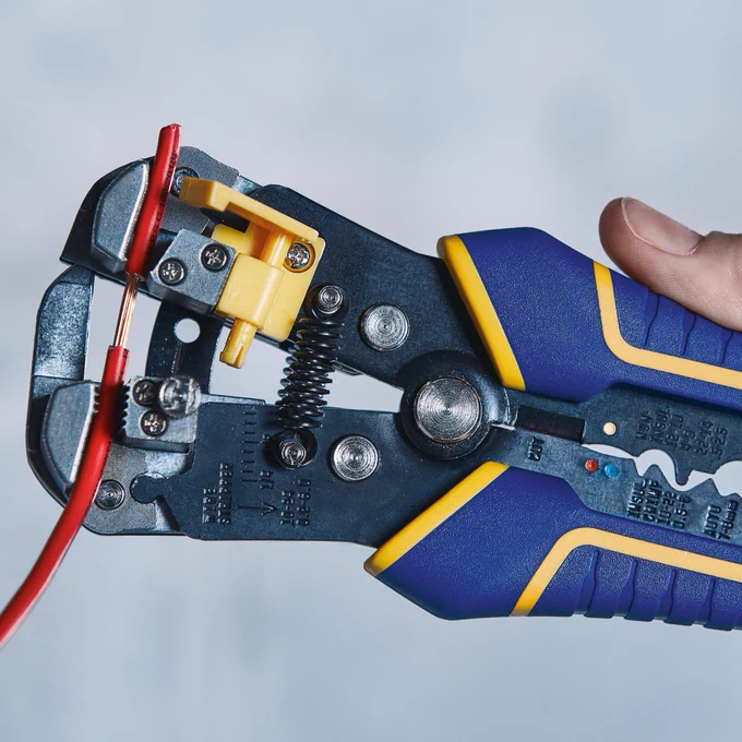 An image of someone using a Vise-Grip® Wire Stripper to control the length of the core strip. 
