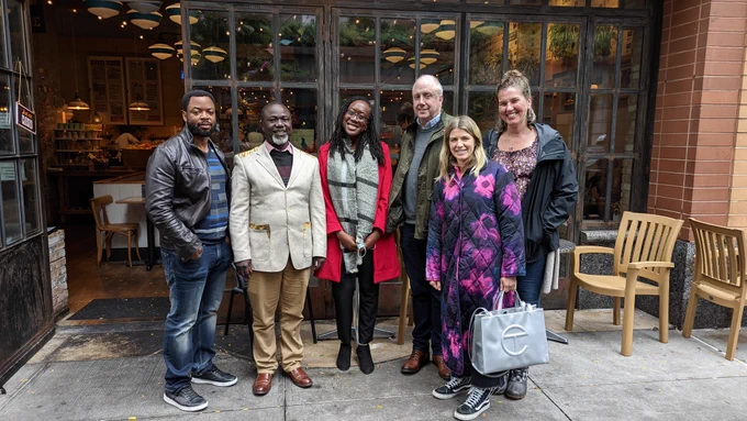 Image of Amref USA staff with Dr. Joachim outside of a restaurant in New York CIty. 