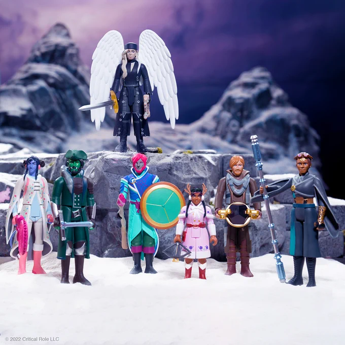 A photo with the full set of Mighty Nein ReAction Figures standing in some snow amongst a wintery backdrop and snow-covered rocks