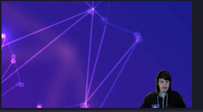 Me setting up stream and looking like @ThePrimeagen who wears a black hoodie against a green screen with the hood on. Also my hoodie is a Gitea hoodie so the green tea cup is chroma keyed out and is showing the purple background that I have behind me.