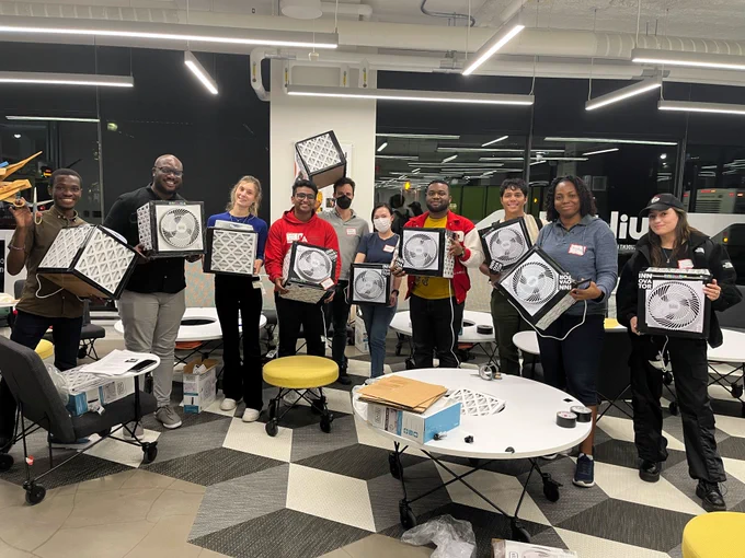 Students proudly displaying their home-made Corsi-Rosenthal air filters