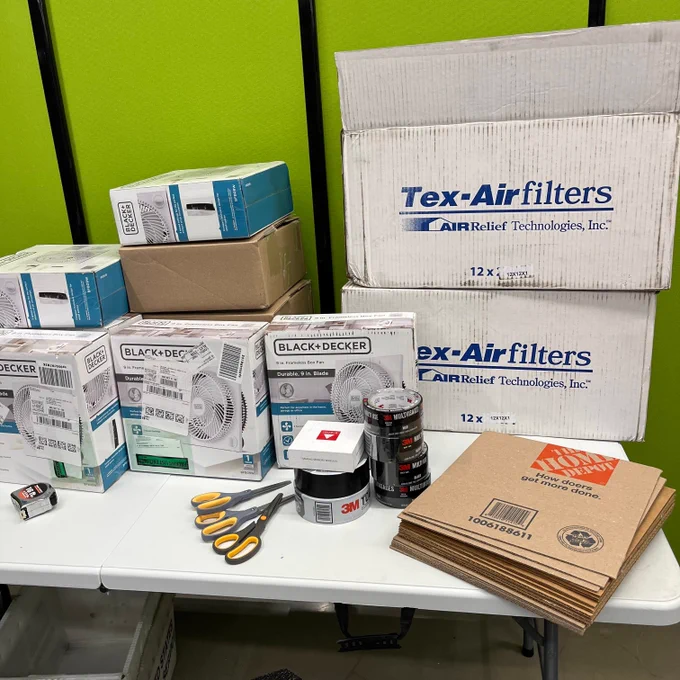 Stack of materials ready to go - fans, cardboard, filters, tape