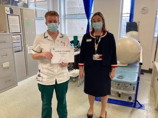 Dr Lara Alloway, chief medical officer, presenting awards to AHP staff