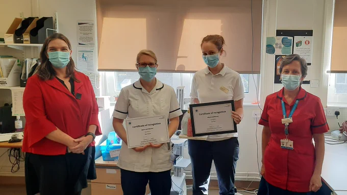 Alex Whitfield, chief executive, presenting awards to AHP staff