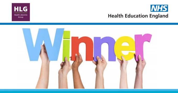 
Hands holding up the letters to the word winner