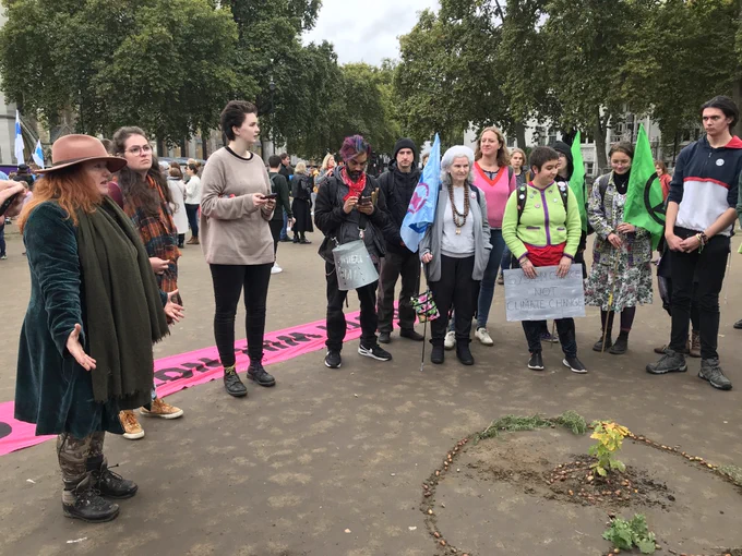 Extinction rebellion protecting the tree in Parliament Square planted by XRYouth