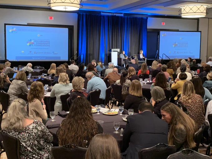 A photo of two speakers addressing a plenary lunch session.