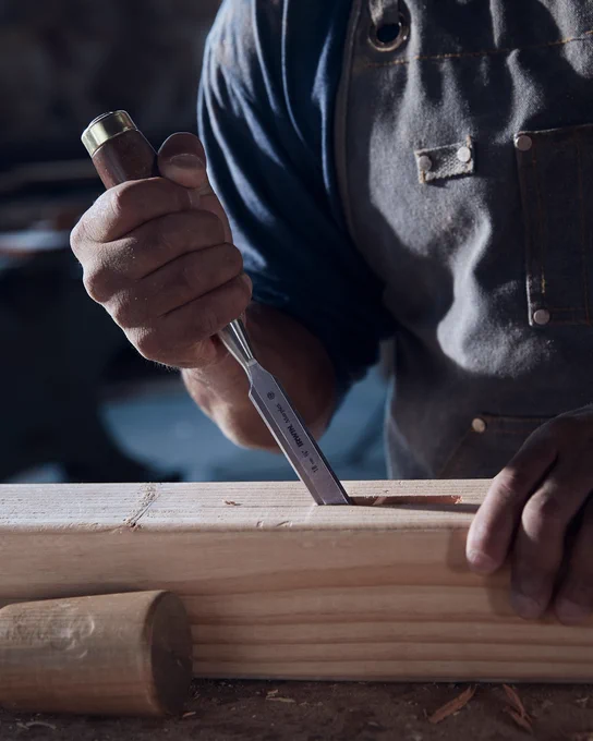 An image of someone grabbing a Vise-Grip® GROOVELOCK™ 10-in Electrical V-jaw Plier off of a metal surface. 