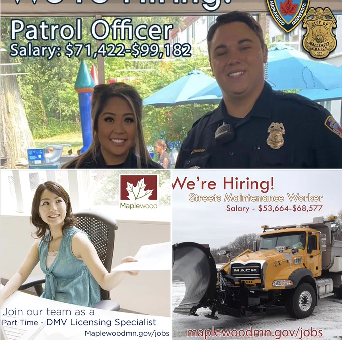 Two officers smiling, specialist holding a piece of paper and a yellow snow plow