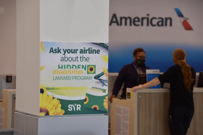 Hidden Disabilities sign near an airline counter.