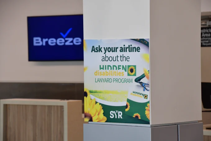 Hidden Disabilities sign near an airline counter.
