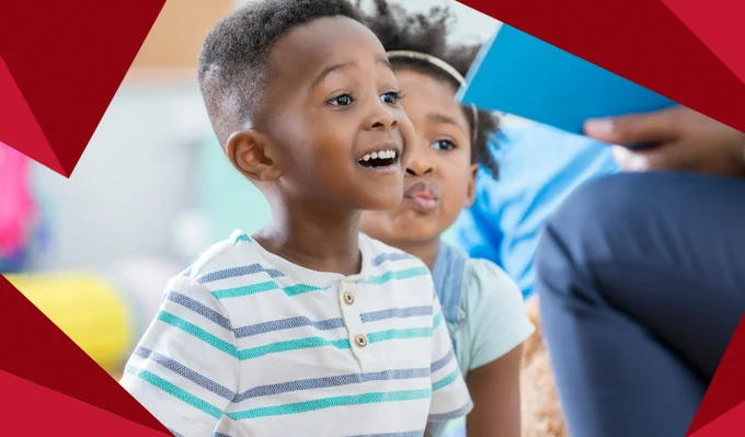 A photo of a smiling boy at a library storytime.