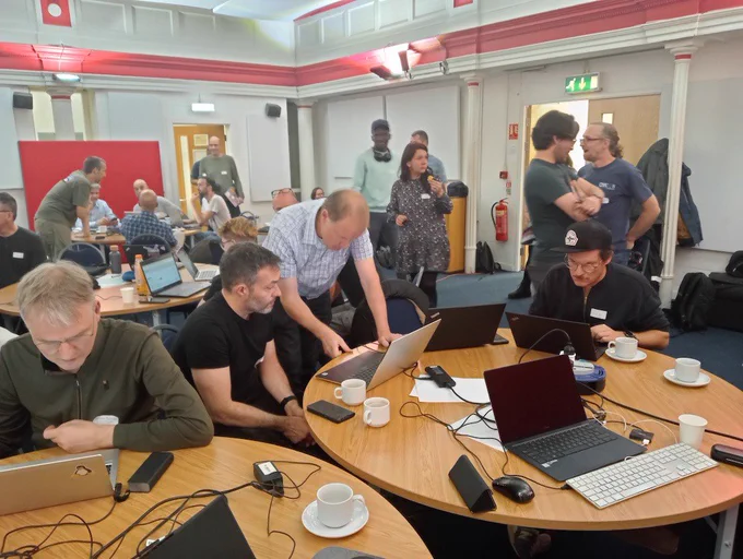 Photograph of lots of people working on laptops in the St Thomas Centre, Manchester for the CiviCRM Sprint.