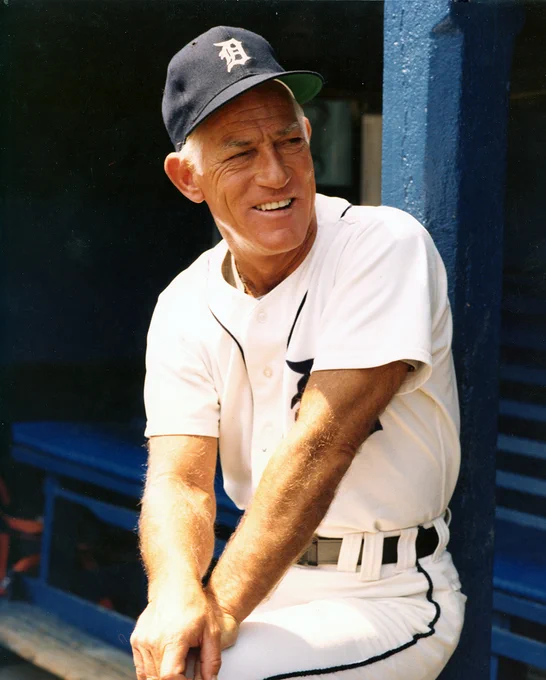 Sparky Anderson sits wearing a white Tigers uniform and blue cap