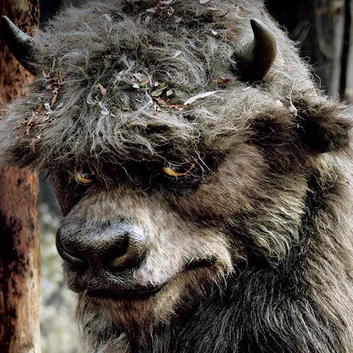 The Bull from Where The Wild Things Are. He is a large bovine monster with dark, nearly black fur all over. His eyes are yellow, and the top of his head is dusted with pieces of leaves. He has sharp black horns at the side of his head.