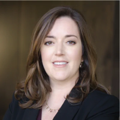 Headshot of Devon Conley. She's wearing a black jacket, purple blouse and gold necklace.