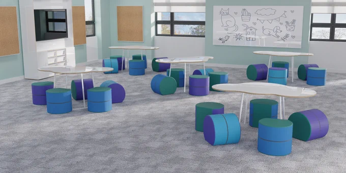 A primary school classroom showing 5 tables in the shape of a cloud. Around each table are 5 ottomans that allow students to sit in different positions or move gently while learning.