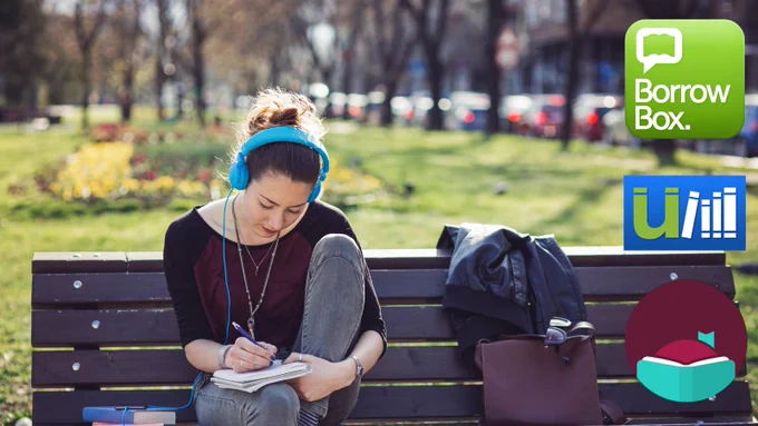 Woman wearing headphones on a park bench