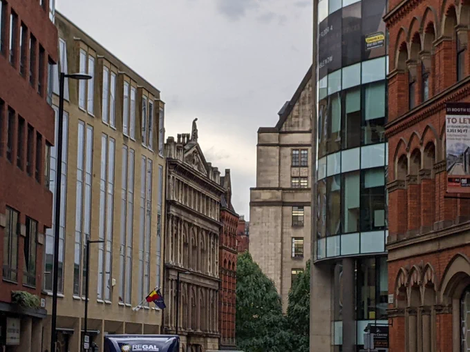 Street scene of buildings in central Manchester looking toward the town hall