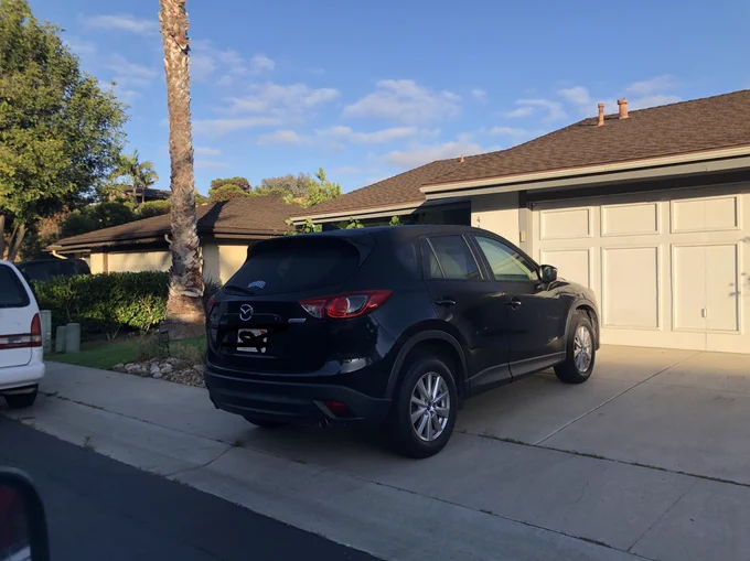 Car parked on sidewalk, blocking access to pedestrians