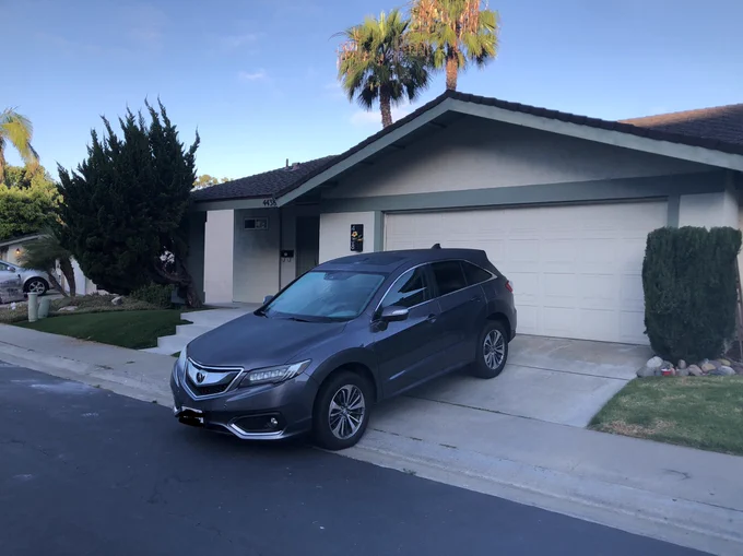 Car parked on sidewalk, blocking access to pedestrians