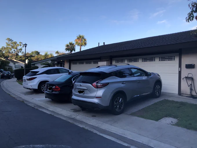 Car parked on sidewalk, blocking access to pedestrians