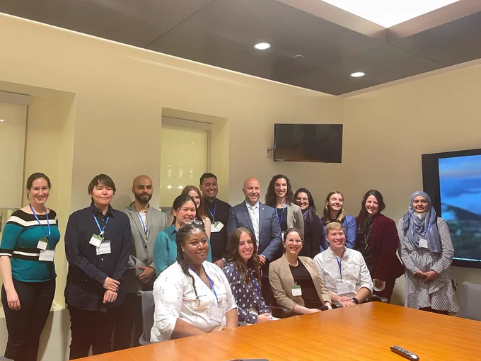 Group photo of Youth Council members with Mr. Andy Fillmore, M.P. for Halifax, standing and sitting in a conference room. 