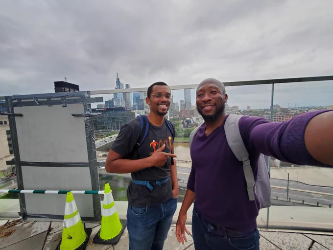 Me and Cornelius posing in front of the Philly skyline