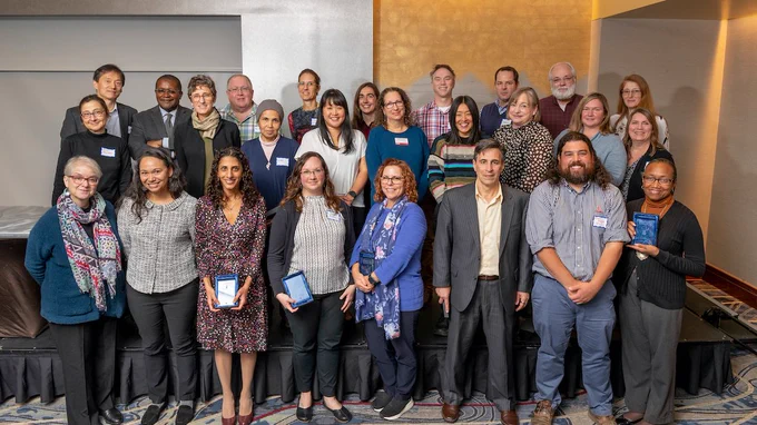 A group of Cornell Engineering faculty and staff smiling for a picture at the EPICC awards ceremony featuring Dr. Nelly Andarawis-Puri in the front row.