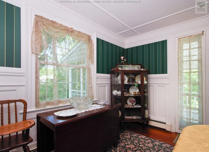 Elegant dining room with new windows we installed. This beautiful new double hung window has that traditional look that matches the antique furniture and sophisticated styling of this formal dining room. Find out more about getting new windows from Renewal by Andersen of Long Island, serving Nassau, Suffolk, Queens and Brooklyn.