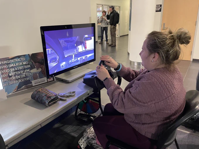 Penn College senior Amanda Leonard drives on the impaired driving simulator at a Penn College safety event.