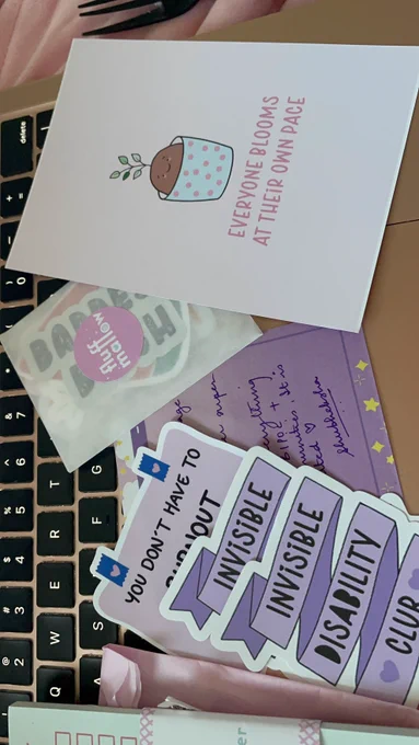 The rest of my stickers from @fluffmallow, and a postcard that says "everyone blooms at their own pace."