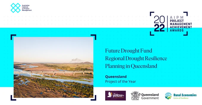 The graphic from the Australian Institute of Project Management includes a photograph of a bridge across a wide river. The text says: 2022 AIPM Project Management Achievement Awards. Future Drought Fund Regional Drought Resilience Planning in Queensland. Queensland Project of the year. Also show are the logos for the Rural Economies Centre of Excellence, the Queensland Government and The Yellow Company.