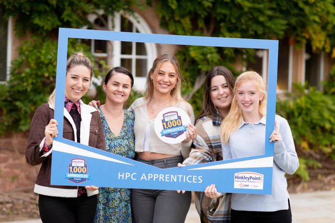 An image of apprentices holding up a selfie frame that reads 'HPC Apprentices'.