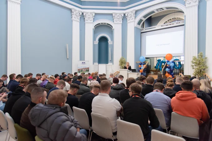 An image of apprentices listening to a speech.