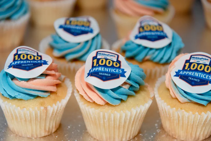 An image showing cakes displayed with decorations reading '1000 apprentices trained'.