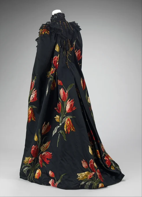 Elegant black opera gown with embroidered tulips across the design.