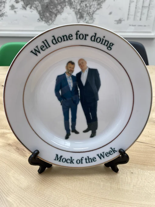 A commemorative plate for the end of Mock the Week, with a picture of Dara and Hugh and the inscription “Well done on doing Mock Of The Week”.