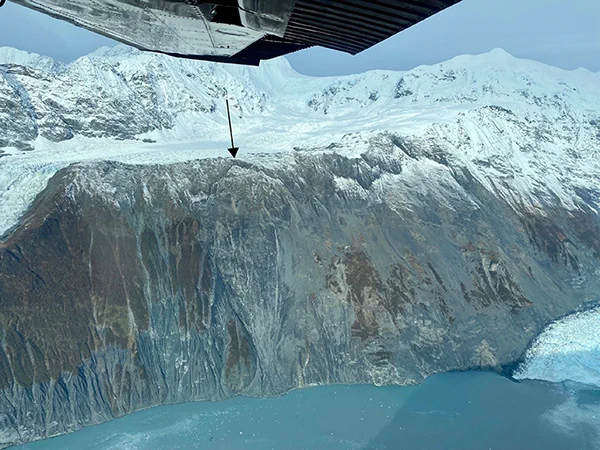 Barry Arm landslide (looking west) with the toe of Barry Glacier visible at bottom right. The black arrow points to the Kite. Photo credit: Katreen Wikstrom Jones (DGGS)