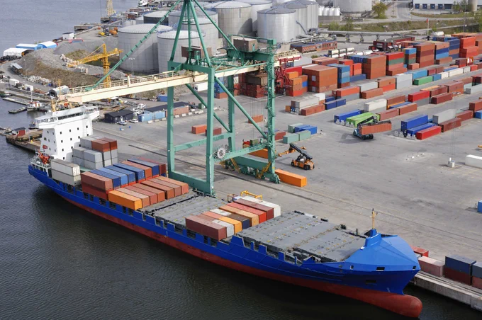Image of a container ship loading at a port