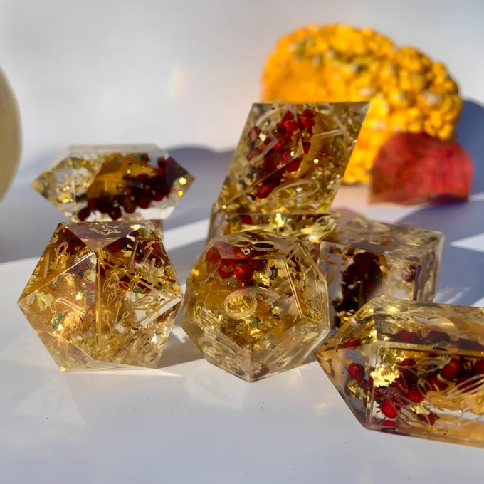 Polyhedral dice for dungeons and dragons or other ttprgs these have lichen, sumac, flower petals, and grass within