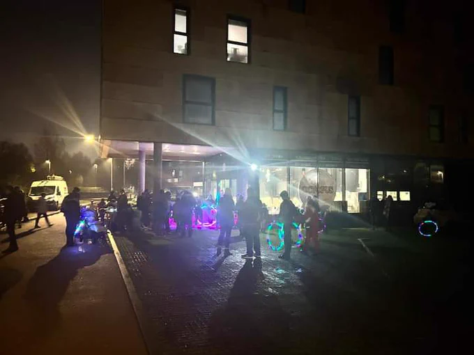 People outside Octopus Lounge with LED hula hoops and other equipment. 
