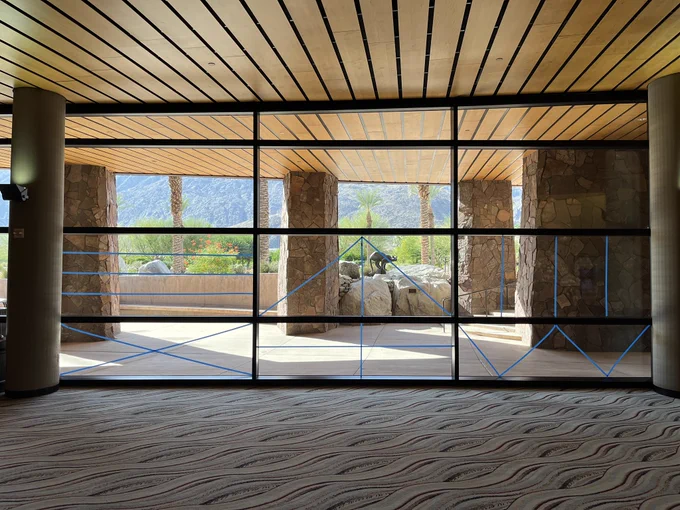 Large windows panels with blue tape patterns