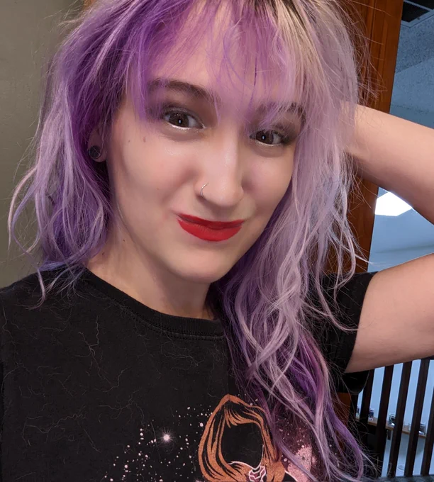 Teshy, with red lipstick, highlight, and grey/white eyeshadows - from cosplaying Morticia Addams. Hair wavy and messy from wearing a wig cap.