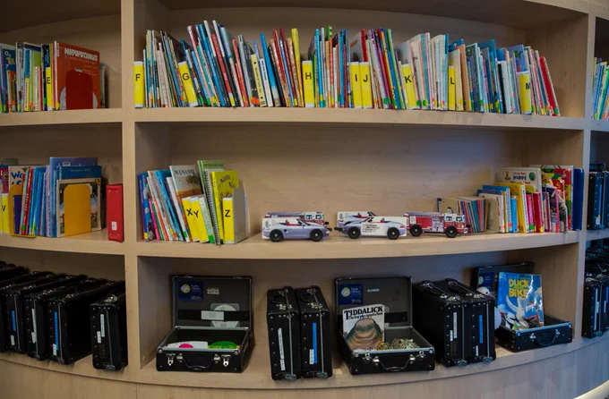 Shelves filled with books categorised alphabetically. 